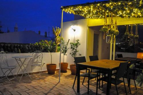 a table and chairs on a patio at night at Elegant Studio Formosa in Taviras Historica Centre in Tavira