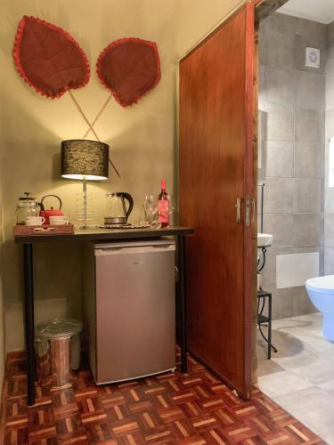 a kitchen with a counter and a sink and a refrigerator at Chic Suite Figueiras w balcony in Taviras Historical Centre in Tavira