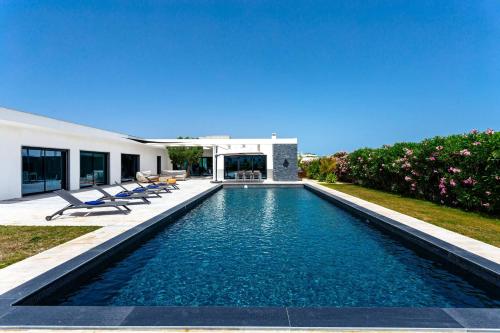 a swimming pool in the backyard of a house at Blue Hill Boutique Villa by Junto ao Mar in Quelfes