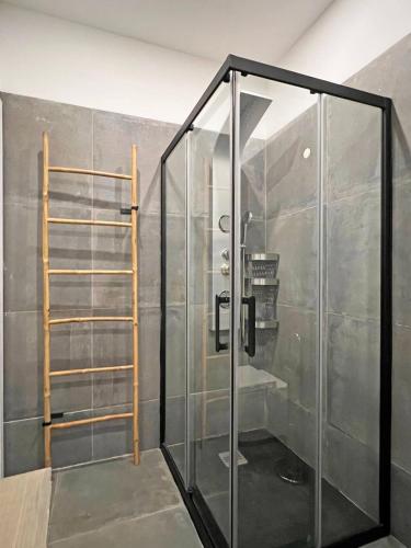 a shower with a glass door in a room at Casa Condessa de Cabanas by Junto ao Mar in Cabanas de Tavira