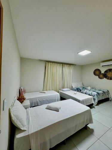 a hospital room with three beds and a window at Pousada du Vento in Cruz