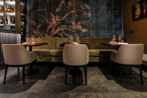 a dining room with two tables and two chairs at U-Visionary Venezia Hotel in Venice