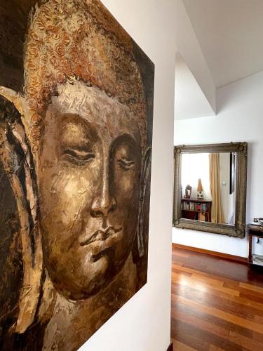 a painting of a face on a wall in a room at Ático en Plaza de la Constitución 3 bedrooms in Málaga