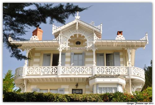 a white house with a balcony on top of it at La Résidence - Thalazur Arcachon in Arcachon