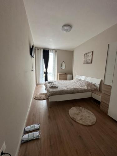 a bedroom with a bed and a large window at SISI Apartment in Tirana