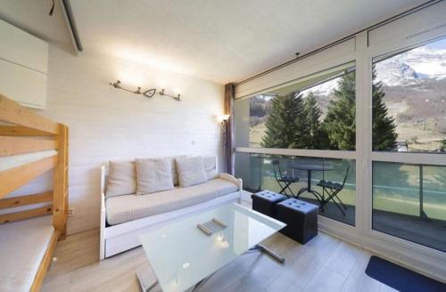 a living room with a couch and a large window at A la montagne in Eaux-Bonnes