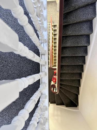 an overhead view of a stairway with white stairs at Acacia Hotel in London