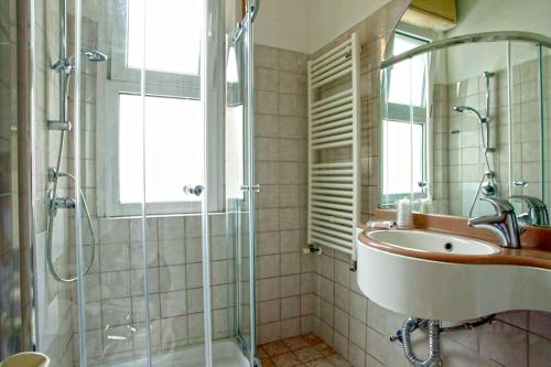 a bathroom with a sink and a shower at Hotel Marebello in Rimini