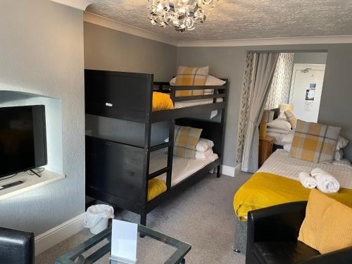 a small room with a bedroom with bunk beds at The Wildings Hotel & Tudno's Restaurant in Llandudno