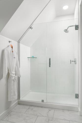 a bathroom with a shower with a robe on a hanger at Island House Newport in Newport