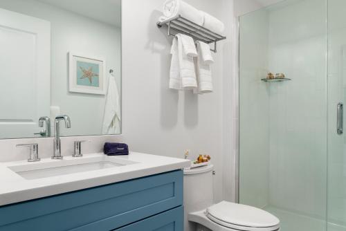 a bathroom with a sink and a toilet and a shower at Island House Newport in Newport