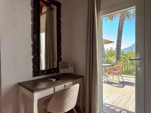 a mirror on a wall next to a table with a chair at Hotel Altea Paradise 1917 - Adults Only in Altea