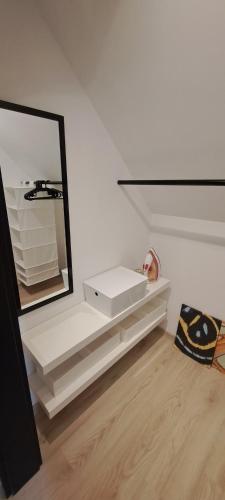 a mirror sitting on a shelf in a room at Domek pod Sosnową Górą 2 in Żelazno