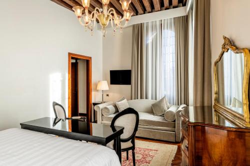 a bedroom with a bed and a desk and a couch at Hotel Casa Verardo Residenza d'Epoca in Venice