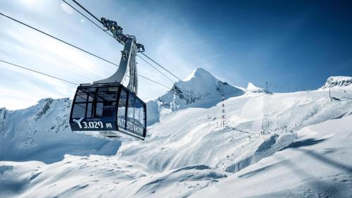 a ski lift going over a snow covered mountain at Haus Almkreek in Kaprun