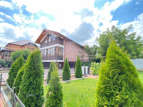 a house with a bunch of trees in front of it at Дом для отпуска in Codru