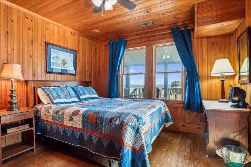 a bedroom with a bed and a window at KD2043- The Gray House in Kill Devil Hills