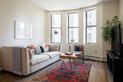 a living room with a couch and a table at Classic Downtown Loft Style Apartment in Boston