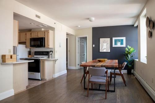 a kitchen and dining room with a table and chairs at Classic Downtown Loft Style Apartment in Boston