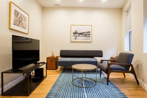 a living room with a couch and a tv at Perfect North End Apt 2BR 2BA Laundry in Boston
