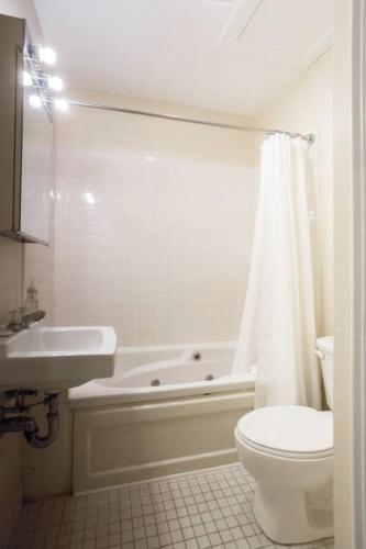 a bathroom with a tub and a toilet and a sink at Perfect North End Apt 2BR 2BA Laundry in Boston