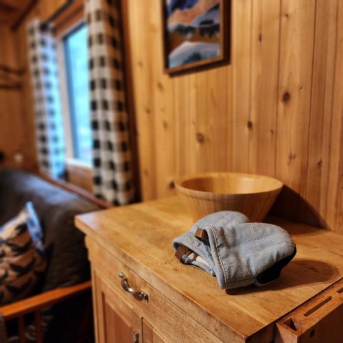 a wooden table with a bowl on top of it at Camp Almanor at Big Springs in Westwood