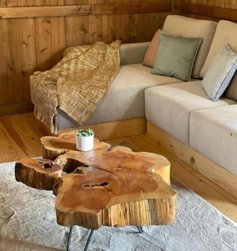 a living room with a couch and two wooden tables at Mountain Eco Shelter 2 in Funchal