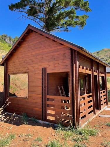 a small wooden building with a large window at Mountain Eco Shelter 4 in Funchal