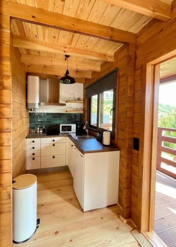 a kitchen in a wooden cabin with a counter top at Mountain Eco Shelter 6 in Funchal