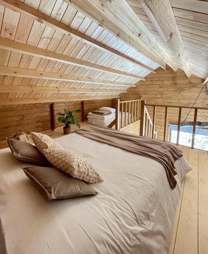 a large bed in a room with a wooden ceiling at Mountain Eco Shelter 5 in Funchal