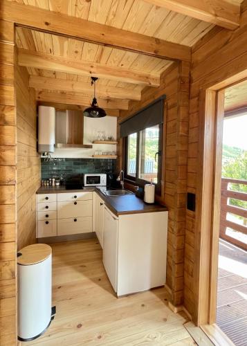 a kitchen in a log cabin with a counter top at Mountain Eco Shelter 5 in Funchal