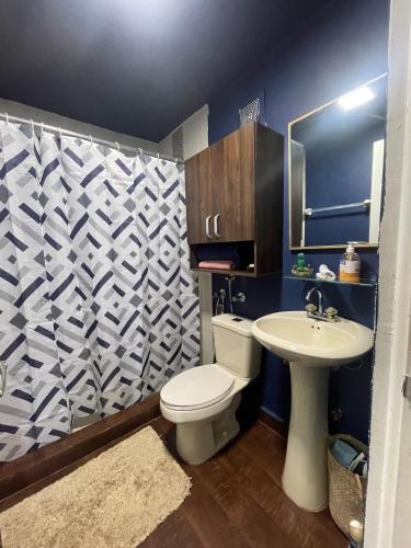 a bathroom with a white toilet and a sink at Mi refugio marino in ArraijÃ¡n