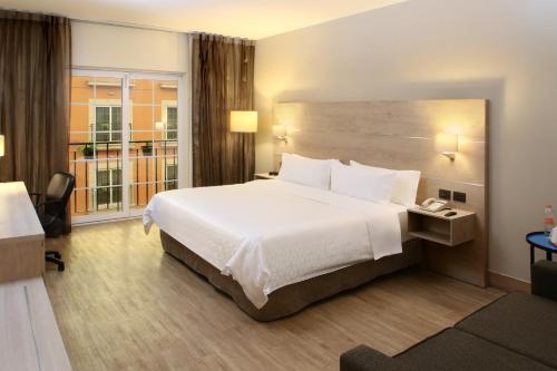 a hotel room with a large bed and a window at Holiday Inn Express Torreon by IHG in Torreón