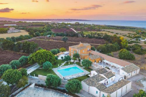an aerial view of a mansion with a swimming pool at Masseria Testaferrata in Siracusa