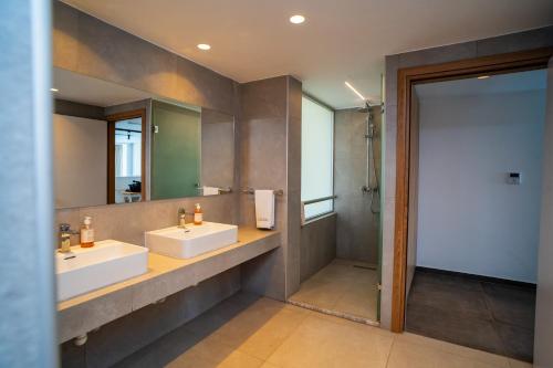 a bathroom with two sinks and a mirror at Malama Beach Holiday Village in Protaras