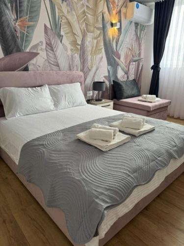 a bedroom with a large bed with two towels on it at Central luxury apartment ROOM 4 in Ohrid