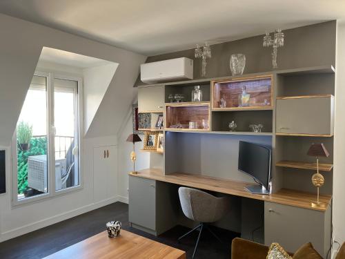 un bureau avec un bureau et une fenêtre dans l'établissement Parenthèse idéale Montorgueil loft In Paris, à Paris