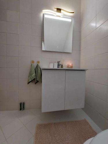 a bathroom with a white cabinet and a mirror at Villa Danai Nefeli Siviri in Siviri