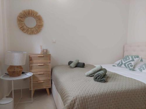 a bedroom with a bed and a table with a mirror at Villa Danai Nefeli Siviri in Siviri