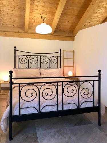 a black bed in a room with a wooden ceiling at Gut Müllerleile Ferienhaus in Gengenbach