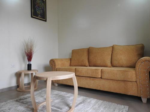 a living room with a couch and a table at Jed Suites in Kampala