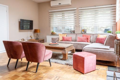 a living room with a couch and a table at Il Forno in Valkenburg