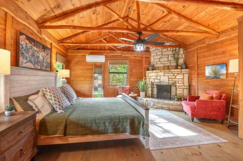 a bedroom with a bed and a fireplace at Sanderson at The Bend in Wimberley