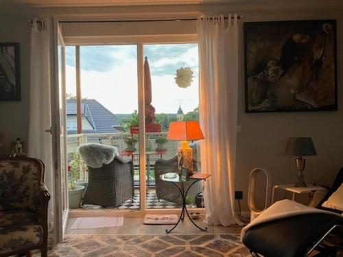 una sala de estar con una gran puerta corredera de cristal en Golfplatz Motzen-Apartment mit Aussicht und vielem Komfort, en Mittenwalde