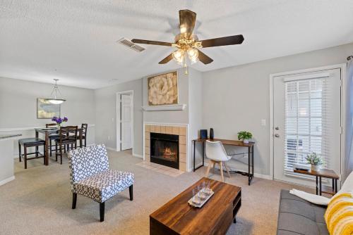 a living room with a ceiling fan and a fireplace at Cozy 2BR Athens Retreat Near UGA and Downtown in Athens