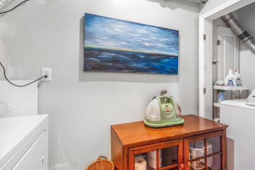 a telephone is sitting on a wooden cabinet in a bathroom at Scenic Gem: Waterfront View, Beach Access in Wading River