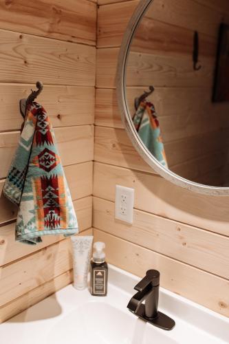 a bathroom with a sink and a mirror at Quiet Country Cabin in Waiparous Village
