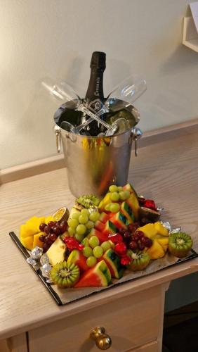 a plate of fruit with a bucket and a bottle of wine at Thon Partner Hotel Kungsbron in Stockholm