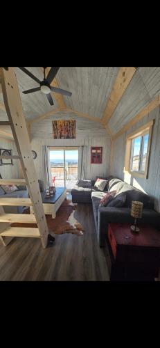 a living room with a couch and a loft at Quiet Country Cabin in Waiparous Village