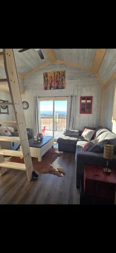 a living room with a bed and a couch at Quiet Country Cabin in Waiparous Village